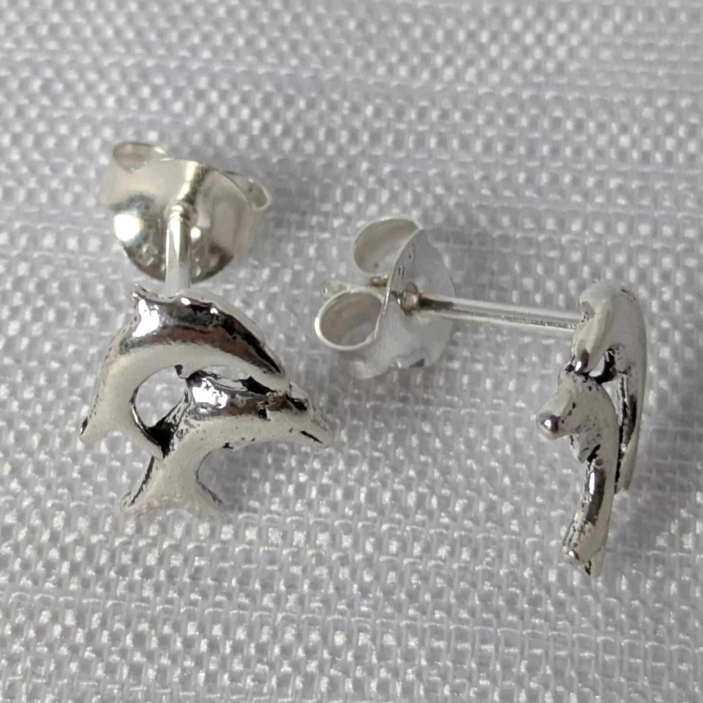 Seitenansicht silberne Delfinstecker mit Verschluss-Detail.