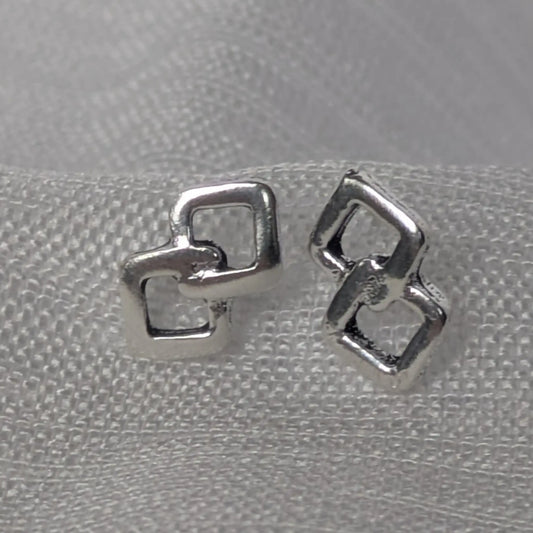 Silberne Ohrstecker mit zwei verschlungenen Rauten in der Frontalansicht auf weißem Stoff.