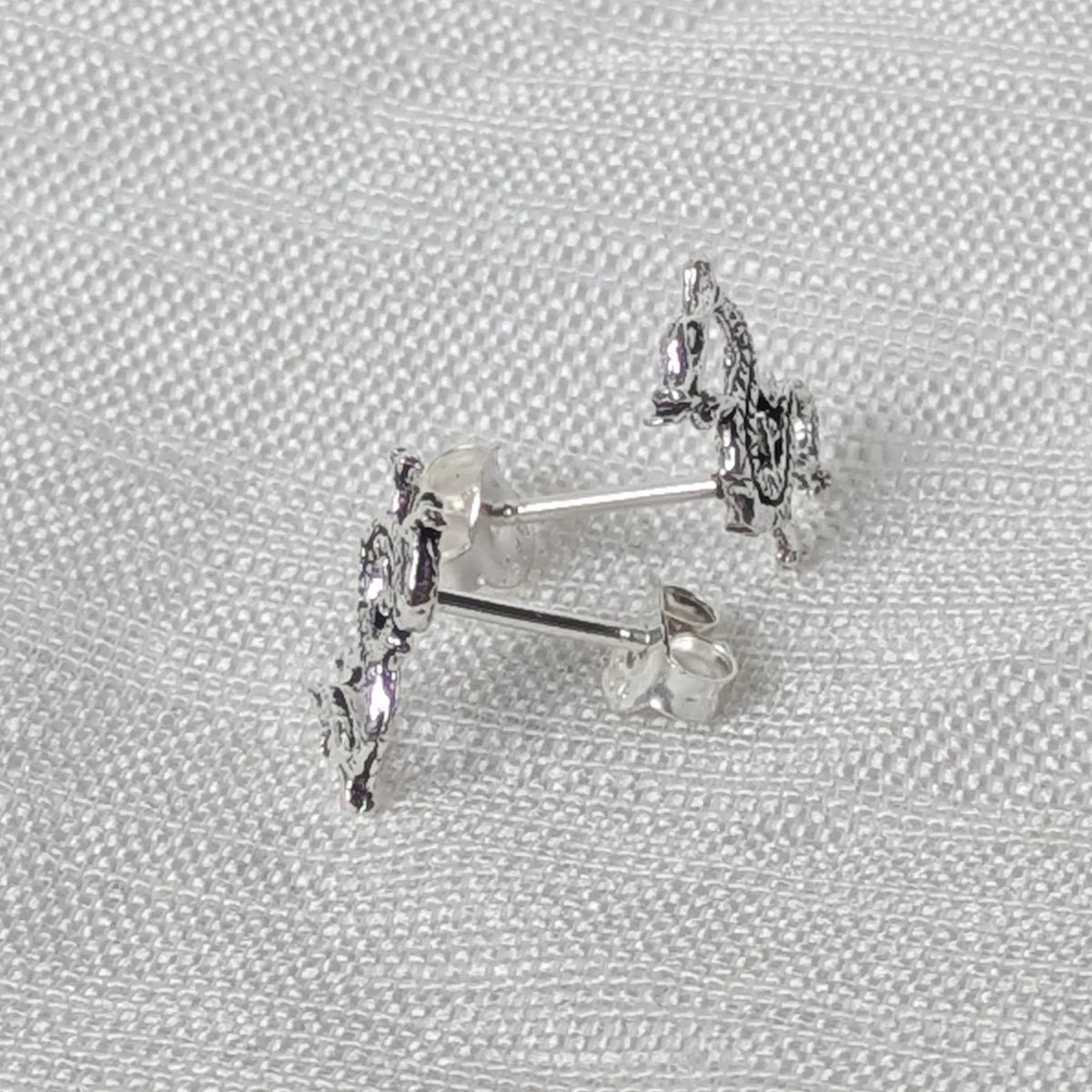 Seitenansicht der Silber-Ohrstecker im Drachen-Motiv zur Veranschaulichung der Materialstärke.
