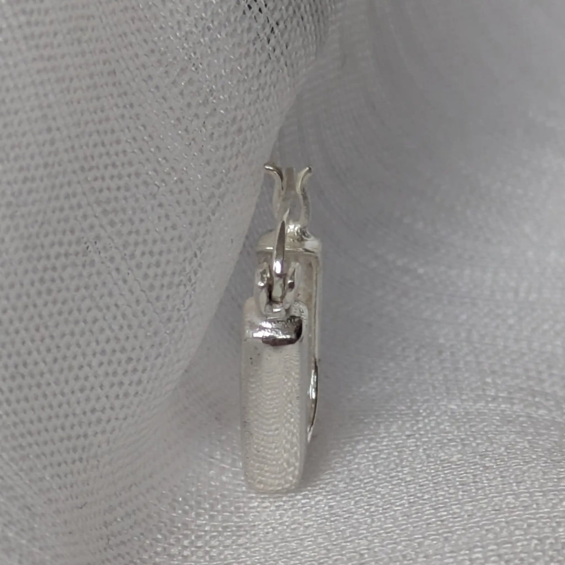 Seitliches Profil der quadratischen Silber-Creolen mit sicherem Klappverschluss.