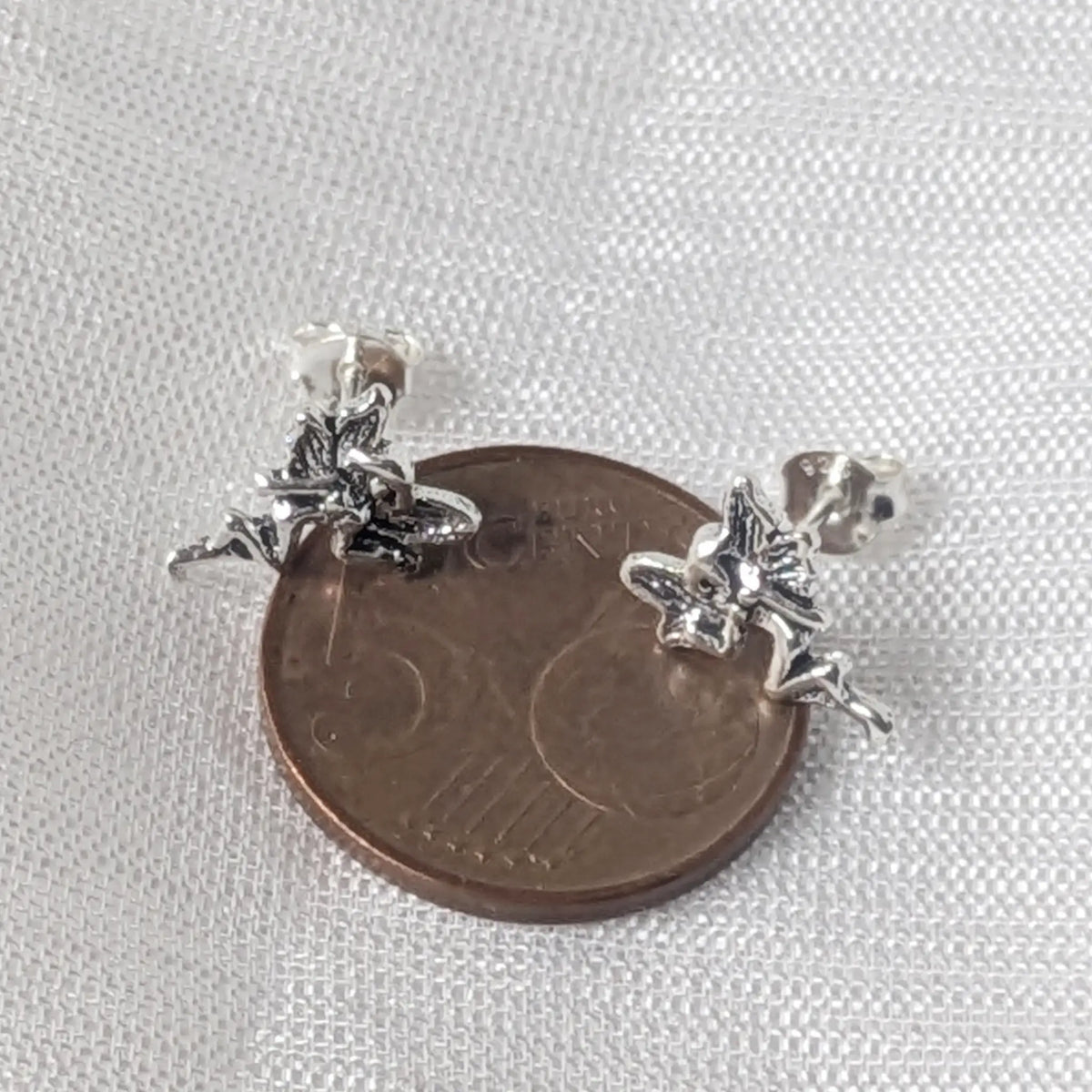 Kleine Elfen Ohrstecker aus Silber im direkten Größenvergleich auf einer 5-Cent-Münze.