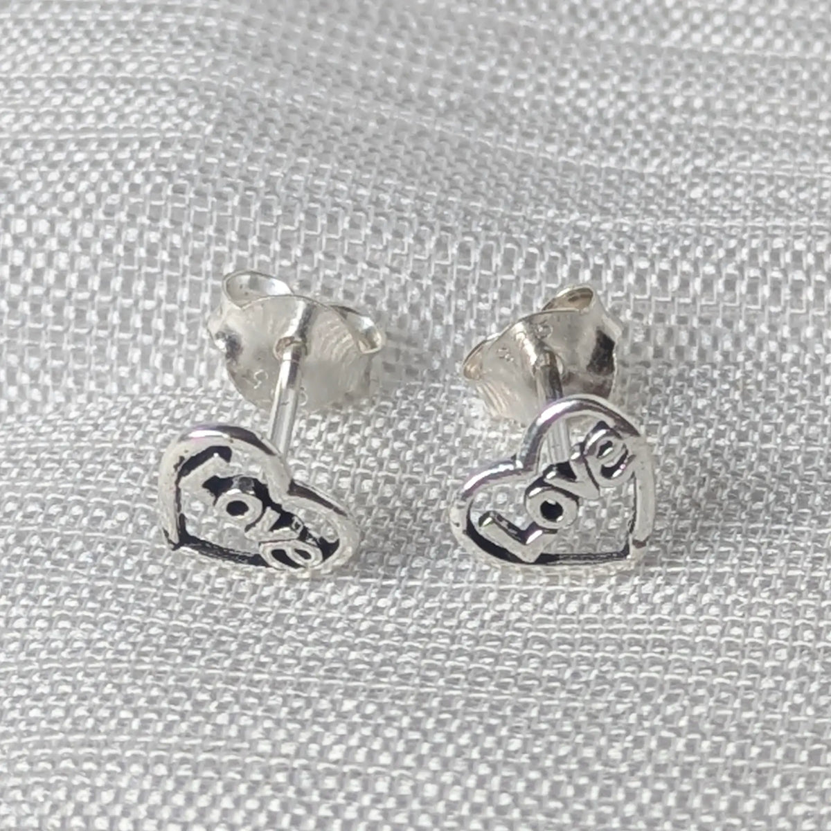 Frontale Ansicht der offenen Love Herz Ohrringe aus feinem Sterling Silber.