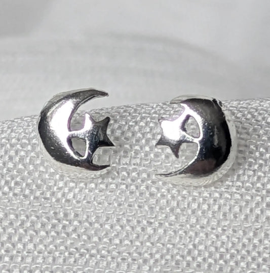 Nahaufnahme von filigranen 925 Silber Ohrsteckern im glänzenden Mond und Stern Design