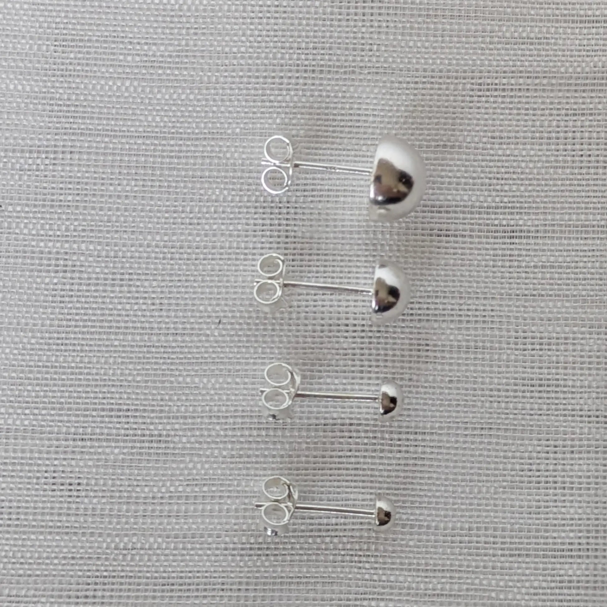 Seitliche Ansicht Halbkugel Ohrstecker Silber gewölbtes Design.