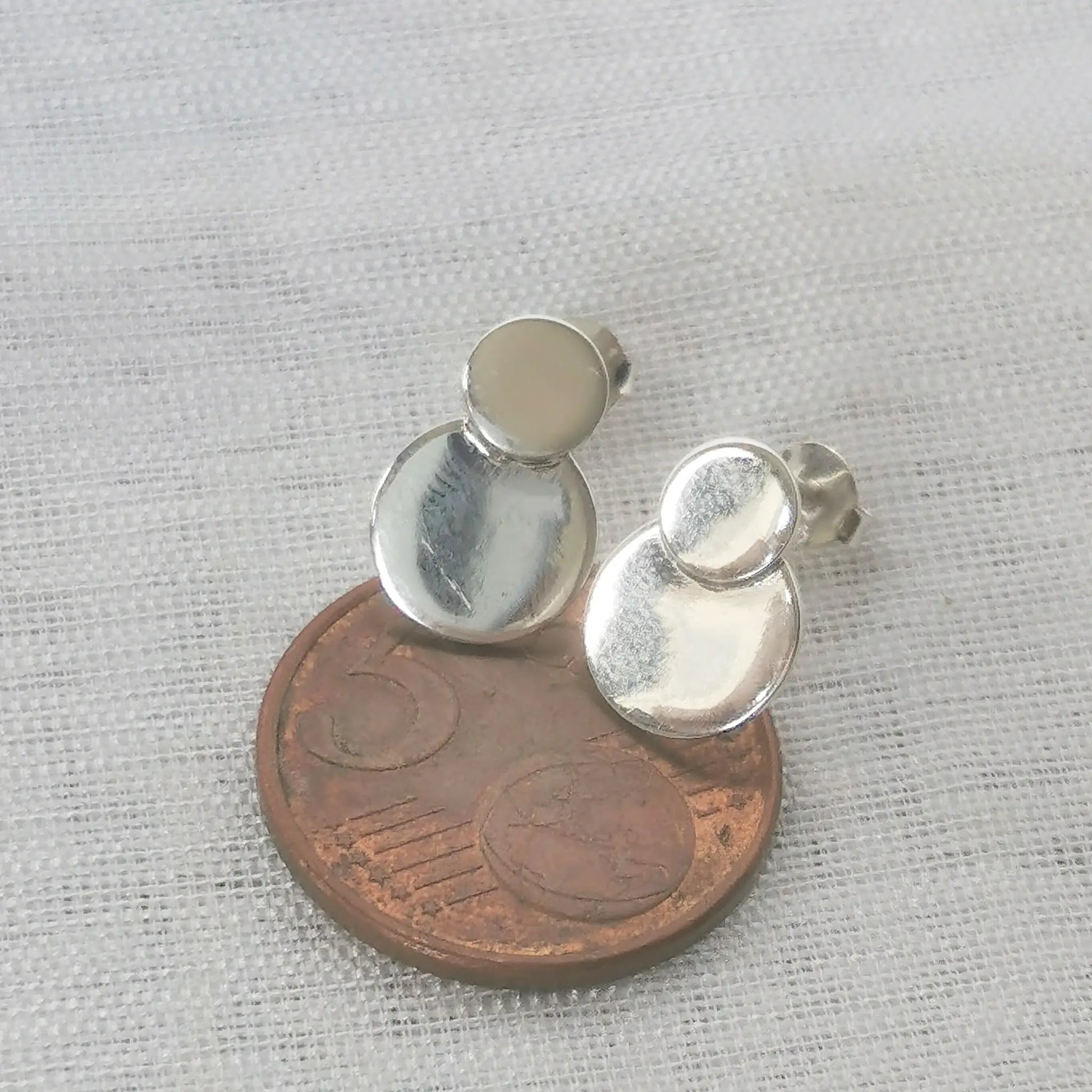 Größenvergleich der minimalistischen Kreis-Ohrstecker platziert auf einer 5-Cent-Münze zur exakten Darstellung der Abmessungen.