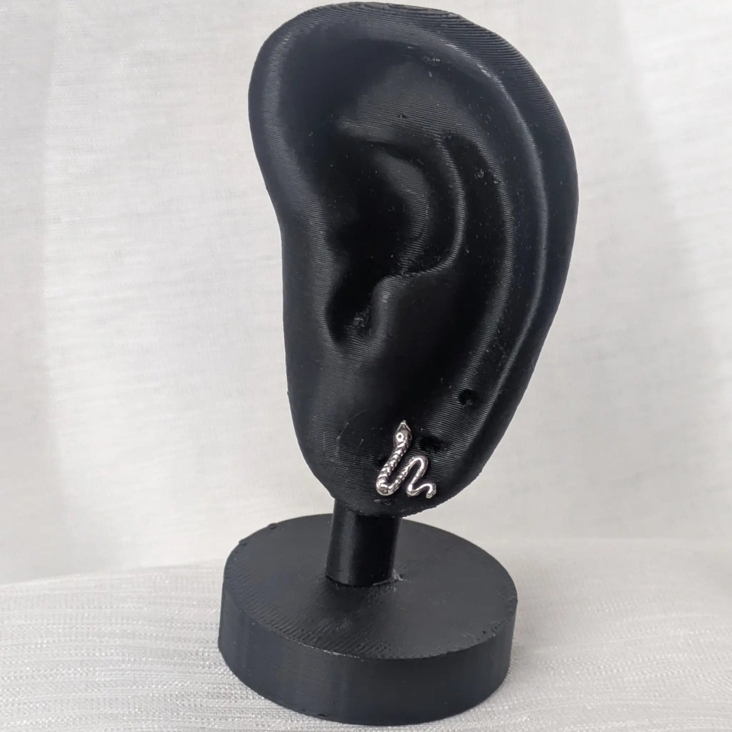 Schlangen Ohrstecker aus 925 Silber präsentiert an einem schwarzen Display.