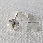 Lade das Bild in den Galerie-Viewer, Detailansicht der strukturierten Silber-Ohrstecker mit reflektierender, handwerklicher Oberfläche.
