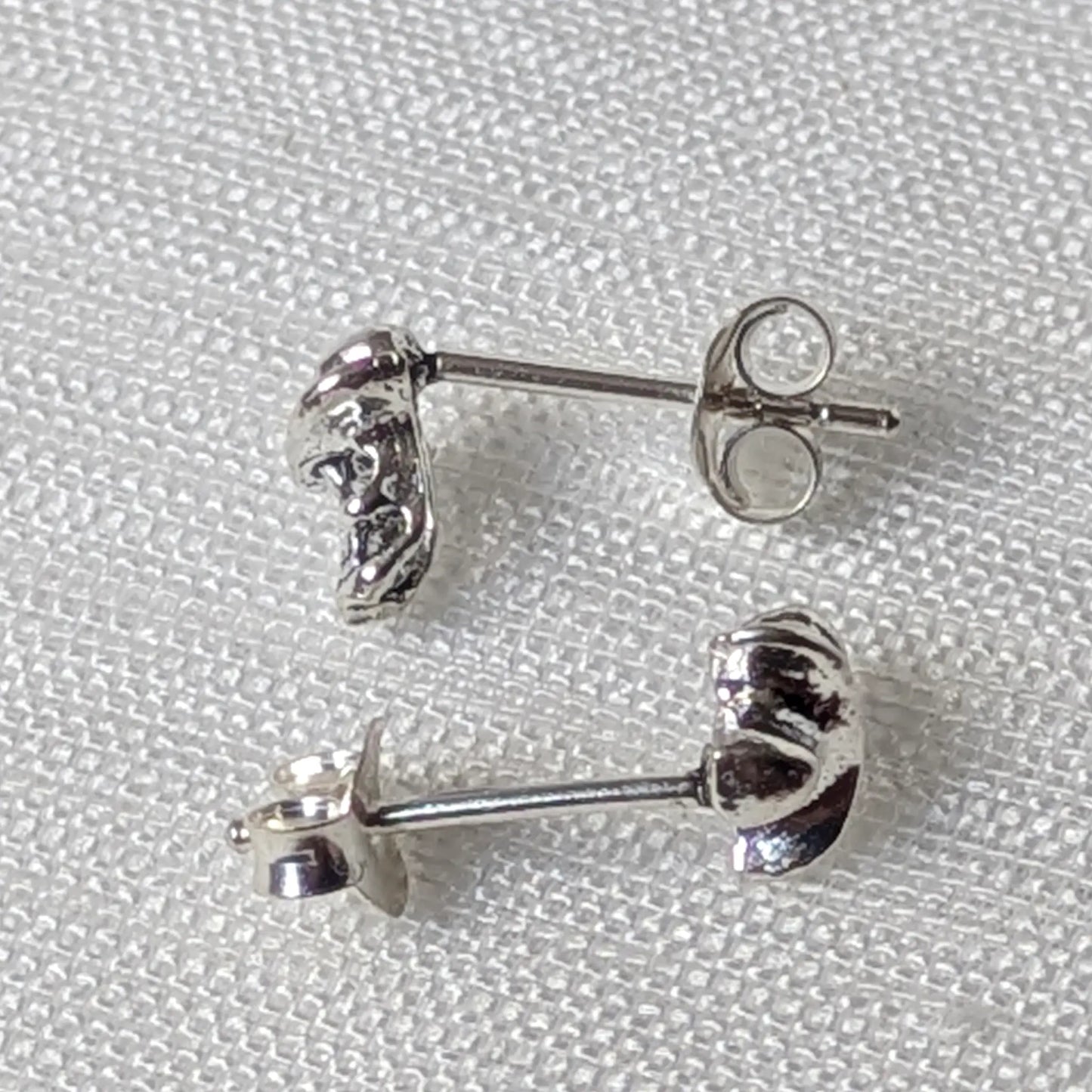 Seitenansicht der 925er Silberohrstecker zeigt das dreidimensionale Design von Totenkopf und Hutkrempe.