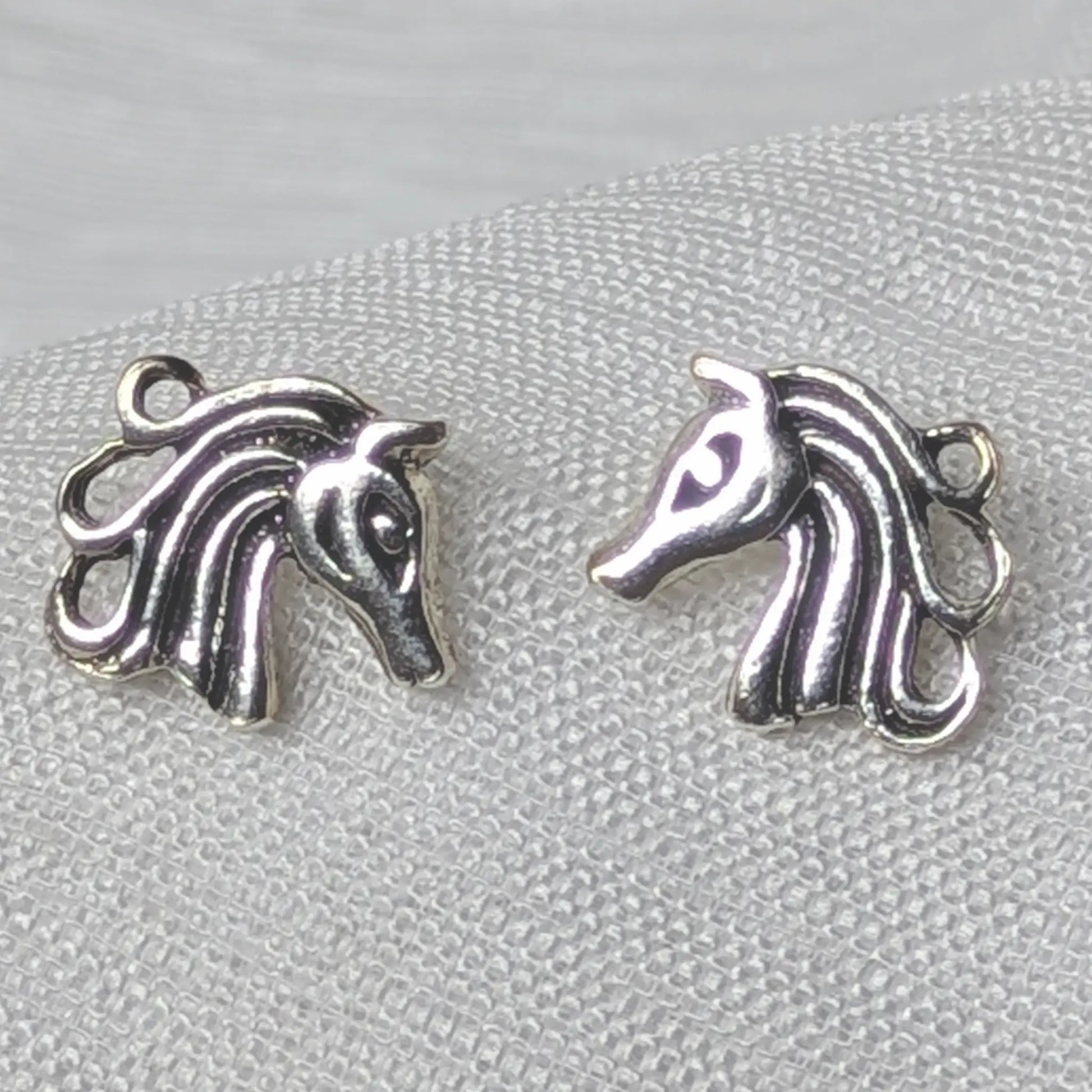 Nahaufnahme von Pferde-Ohrsteckern aus 925 Sterling Silber mit detaillierter Mähne.